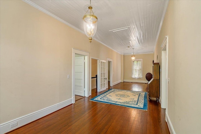 interior space featuring ornamental molding and dark hardwood / wood-style flooring