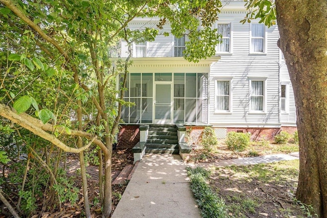 view of front of house featuring a sunroom