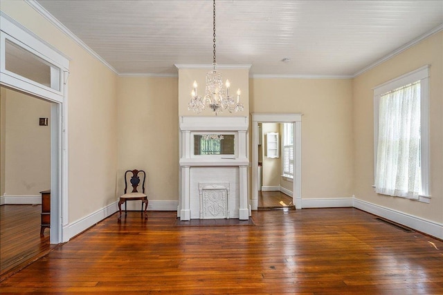 interior space with ornamental molding, a healthy amount of sunlight, dark hardwood / wood-style floors, and a chandelier