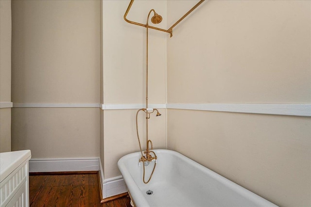 bathroom with a bathing tub and hardwood / wood-style floors