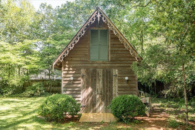 view of outbuilding with a yard