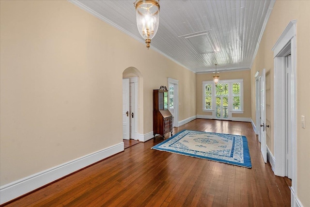 interior space with ornamental molding and dark hardwood / wood-style floors