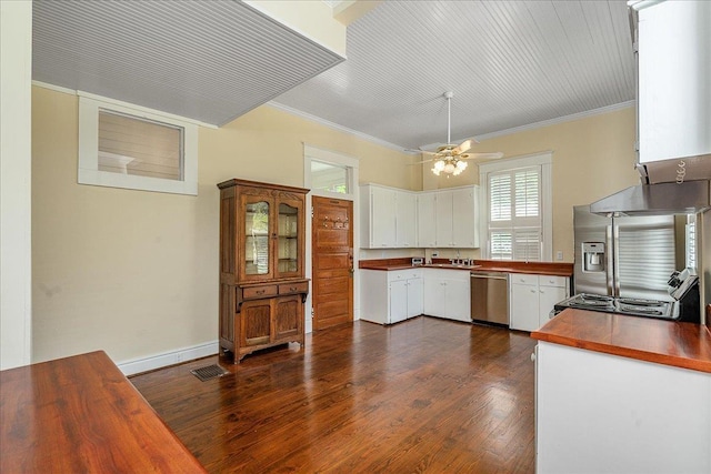 kitchen featuring white cabinetry, ornamental molding, dark hardwood / wood-style floors, ceiling fan, and stainless steel appliances