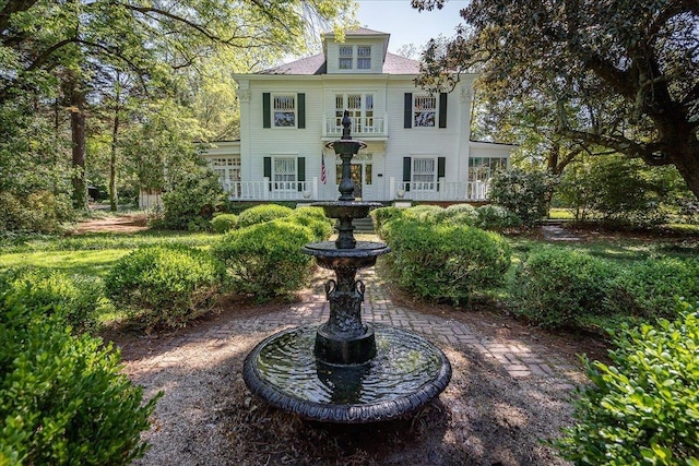 colonial inspired home featuring a balcony