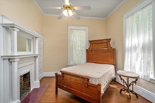 bedroom with crown molding, ceiling fan, and dark hardwood / wood-style floors