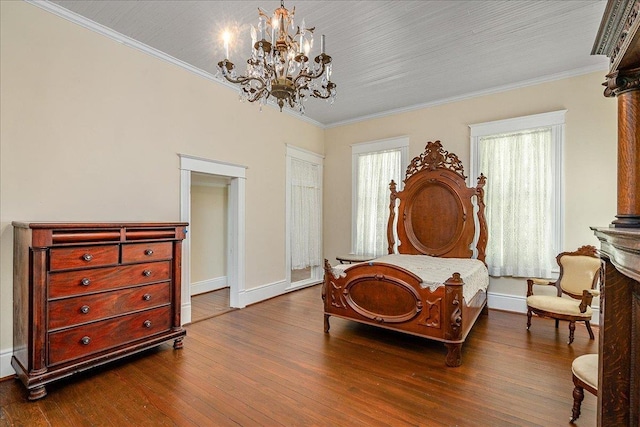 bedroom with hardwood / wood-style flooring, crown molding, and a chandelier