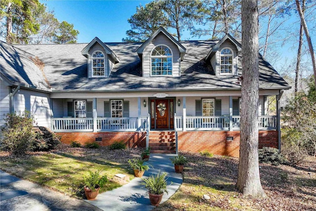 new england style home with a porch