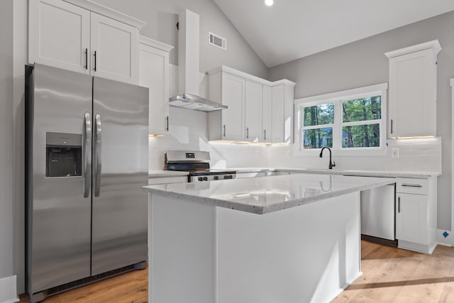 103 Spruce Ln, Eatonton, GA 31024 - kitchen featuring white cabinetry, a kitchen island, appliances with stainless steel finishes, and vaulted ceiling