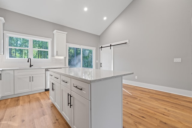 103 Spruce Ln, Eatonton, GA 31024 - kitchen with a sink, a barn door, light wood-style flooring, recessed lighting, and healthy amount of natural light