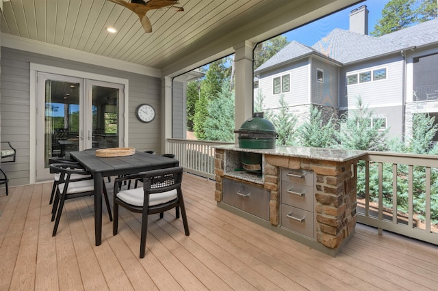 wooden terrace with area for grilling and ceiling fan