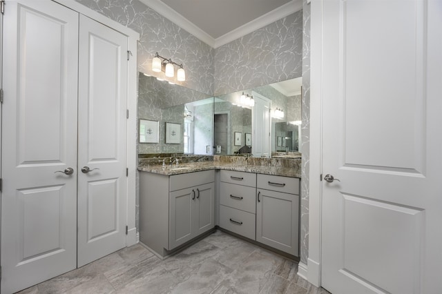 bathroom with ornamental molding and vanity