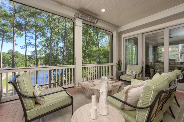 sunroom with a water view and wooden ceiling