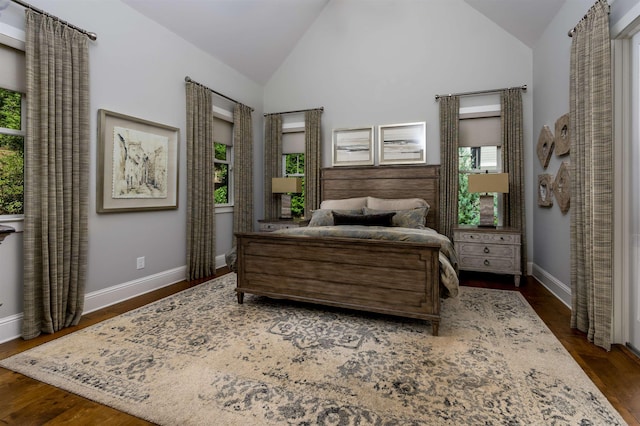 bedroom with dark wood-type flooring and lofted ceiling