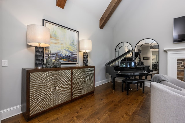 interior space with high vaulted ceiling, dark hardwood / wood-style floors, and beamed ceiling