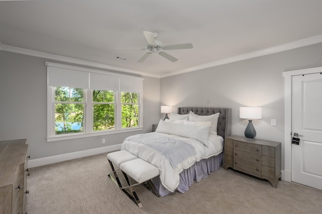 carpeted bedroom featuring ceiling fan and ornamental molding