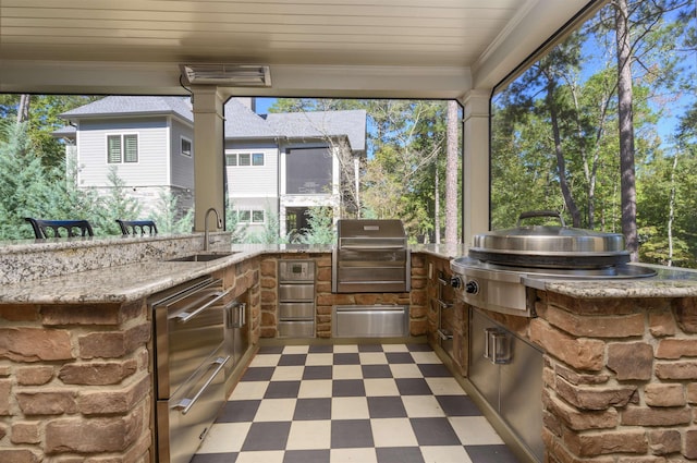 view of patio with a grill, an outdoor kitchen, and sink