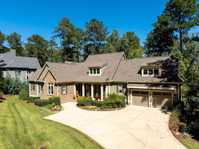 view of front of property with a garage, covered porch, and a front yard