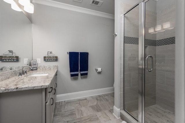 bathroom featuring a shower with door, ornamental molding, and vanity