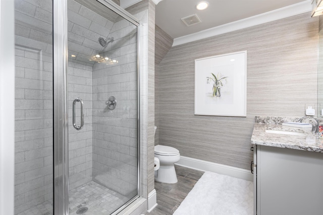 bathroom featuring vanity, a shower with shower door, wood-type flooring, and toilet