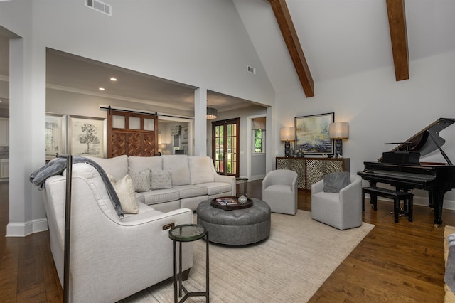 living room featuring hardwood / wood-style flooring, high vaulted ceiling, a barn door, and beamed ceiling