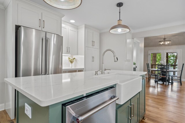 291 Power Point Rd, Milledgeville, GA 31061 - kitchen featuring stainless steel appliances, light wood-style flooring, hanging light fixtures, light stone counters, and a kitchen island with sink