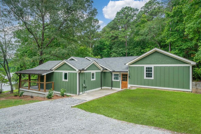 291 Power Point Rd, Milledgeville, GA 31061 - view of front of house featuring board and batten siding, a porch, a front yard, and driveway