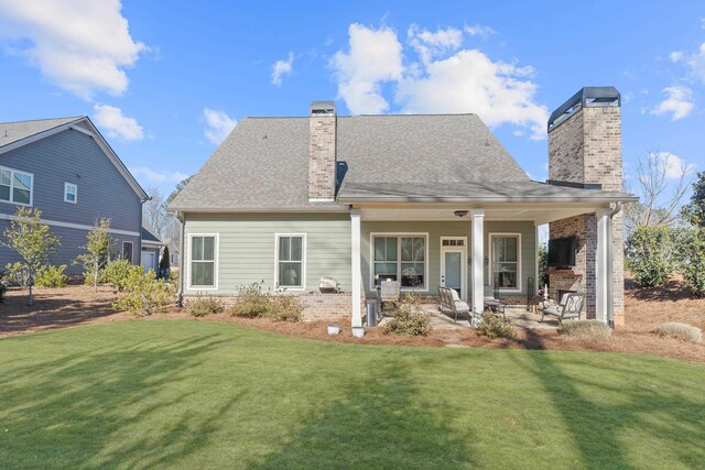 back of property featuring a patio and a lawn