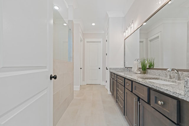 bathroom featuring crown molding, vanity, and tile patterned flooring