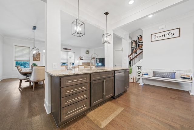 kitchen featuring sink, hanging light fixtures, stainless steel dishwasher, dark hardwood / wood-style floors, and light stone countertops