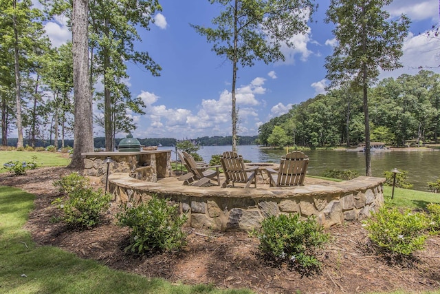 view of patio / terrace with grilling area and a water view