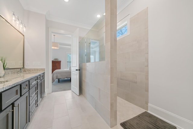 bathroom featuring tile patterned floors, vanity, and a tile shower