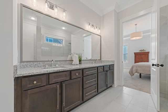 bathroom with tile patterned flooring, vanity, ornamental molding, and a tile shower