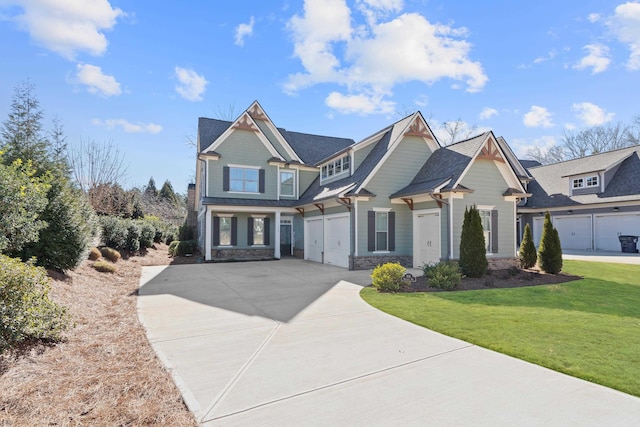 craftsman house with a garage and a front yard