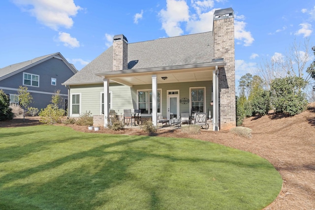 back of house featuring a yard and a patio