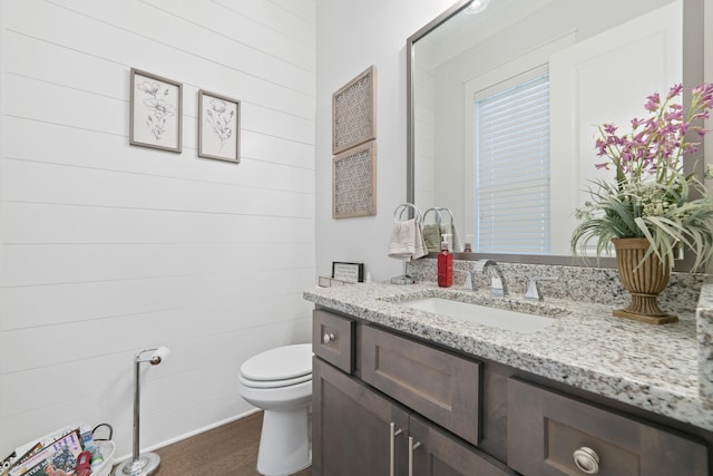 bathroom featuring vanity and toilet