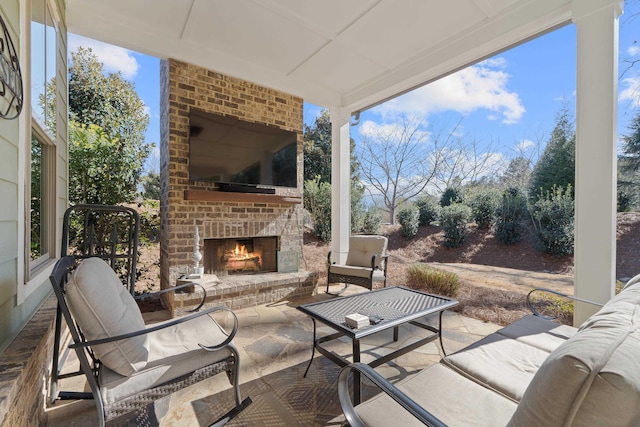 view of patio with an outdoor brick fireplace