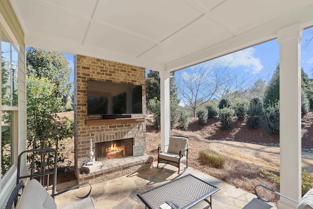 view of patio with an outdoor brick fireplace