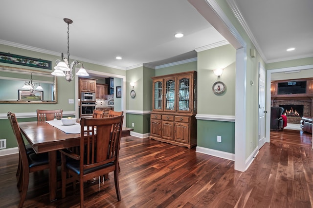 165 Lakeview Dr, Eatonton, GA 31024 - dining space with dark wood-style flooring, ornamental molding, baseboards, recessed lighting, and a lit fireplace