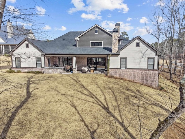 back of house with a lawn and a patio area