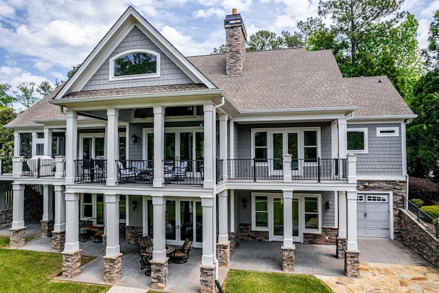 1101 Shoal Creek Ct, Greensboro, GA 30642 - back of property featuring french doors, a balcony, roof with shingles, and a chimney
