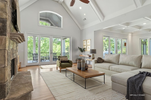 1101 Shoal Creek Ct, Greensboro, GA 30642 - living room with beam ceiling, a stone fireplace, french doors, a ceiling fan, and visible vents