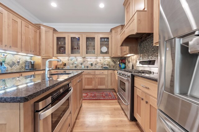 1101 Shoal Creek Ct, Greensboro, GA 30642 - kitchen with light brown cabinetry, a sink, stainless steel appliances, tasteful backsplash, and ornamental molding