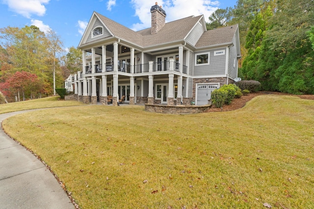 1101 Shoal Creek Ct, Greensboro, GA 30642 - back of house with a chimney, roof with shingles, a balcony, a yard, and stone siding