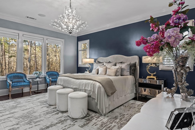 bedroom featuring an inviting chandelier, hardwood / wood-style floors, and ornamental molding