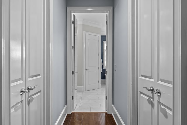 hall featuring crown molding and dark hardwood / wood-style flooring