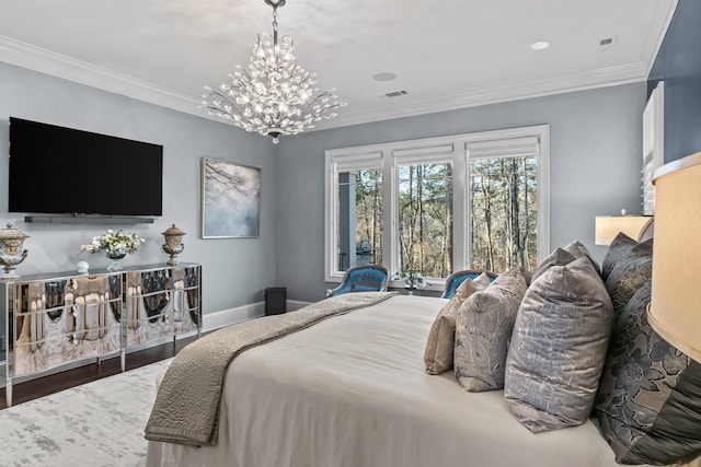 bedroom featuring an inviting chandelier, hardwood / wood-style floors, and ornamental molding