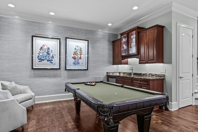 recreation room with pool table, dark wood-type flooring, ornamental molding, and bar area