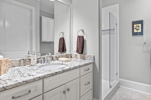 bathroom with ornamental molding, vanity, a shower with shower door, and tile patterned flooring