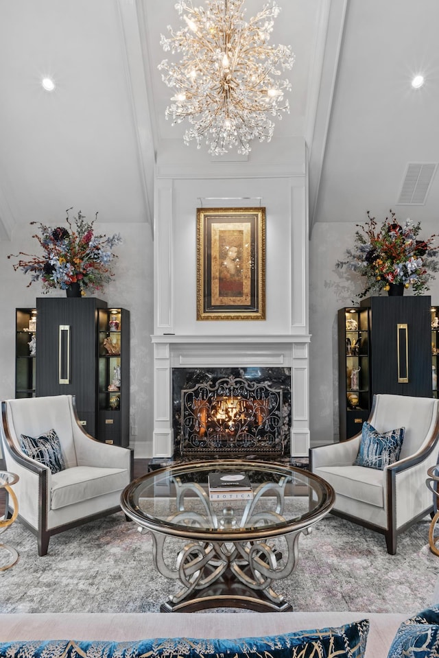 living room featuring an inviting chandelier and a high end fireplace