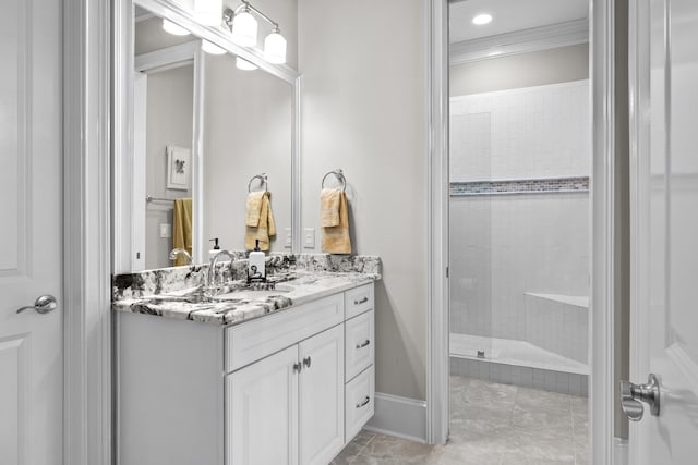 bathroom with vanity, tiled shower, and ornamental molding